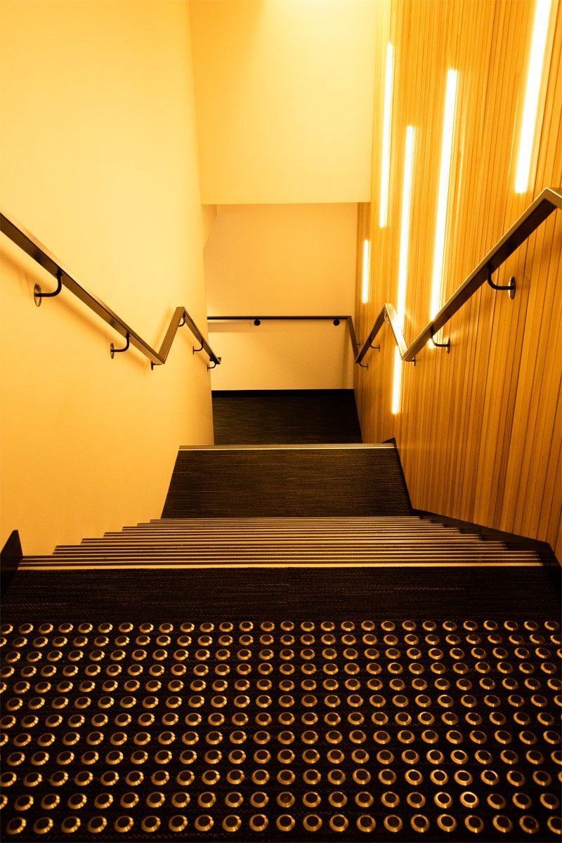 Stainless steel warning tactile indicators installed at a staircase landing to improve blind accessibility, pedestrian safety, and AS 1428 compliance.